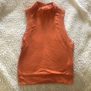 Rusty orange tank top. Somewhat cropped. High neck